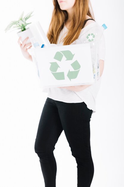 Close-up of woman holding recycle rubbish crate on white background