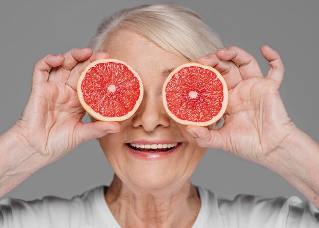 Close-up woman holding red orange slices