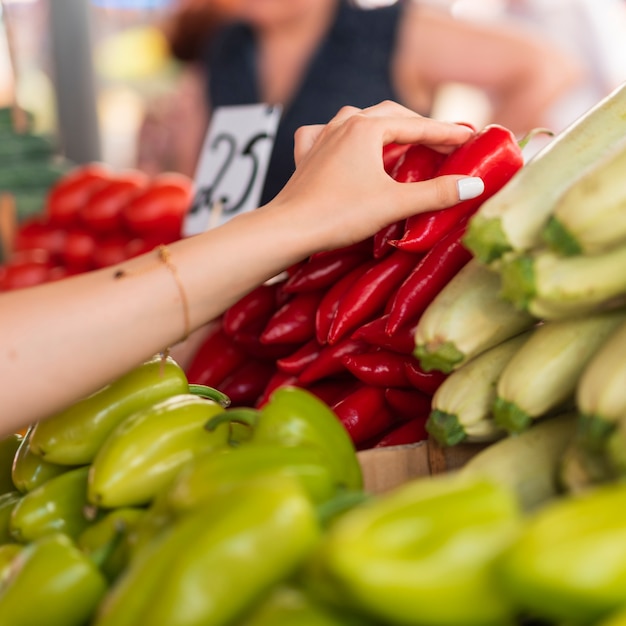 Close-up woman holding a red pepper