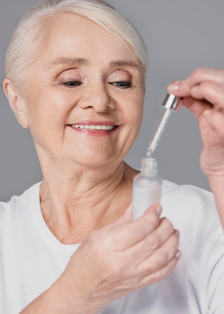 Close-up woman holding serum