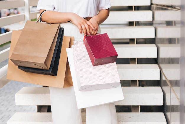 Close-up woman holding shopping bags