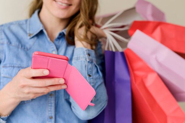 Close-up woman holding shopping bags