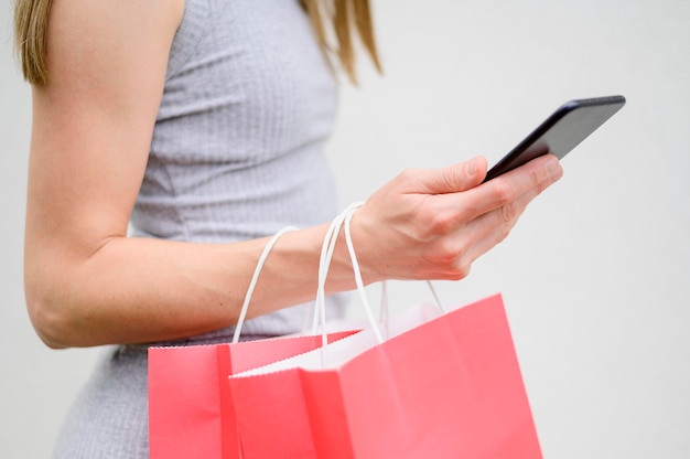 Close-up woman holding shopping bags