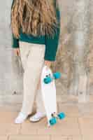 Free photo close-up woman holding skateboard