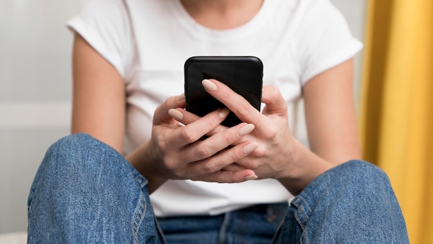 Close-up woman holding smartphone