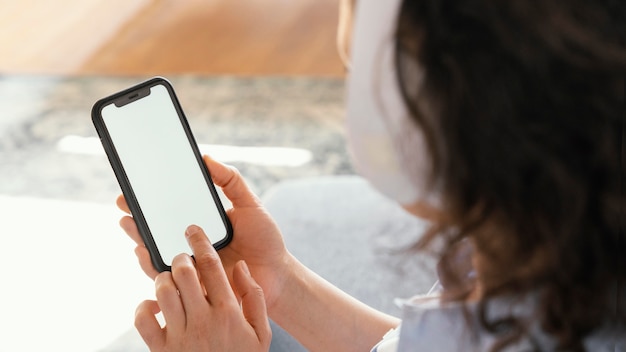 Close up woman holding smartphone