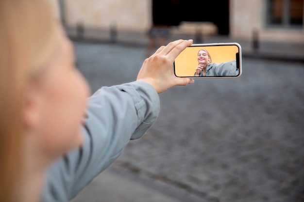 Free photo close up woman holding smartphone