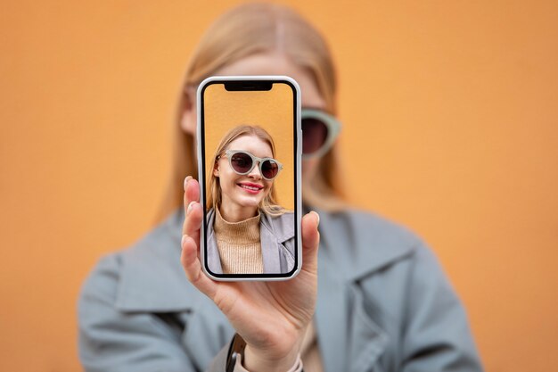 Close up woman holding smartphone