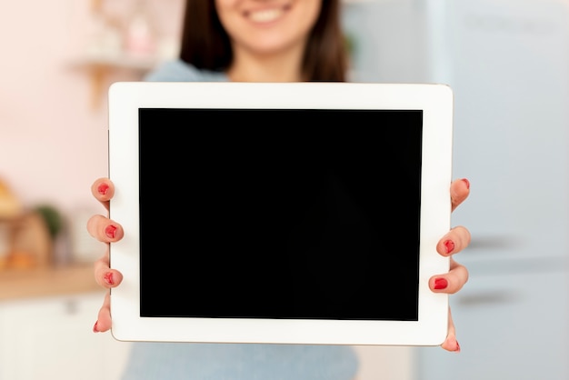 Close-up woman holding a tablet