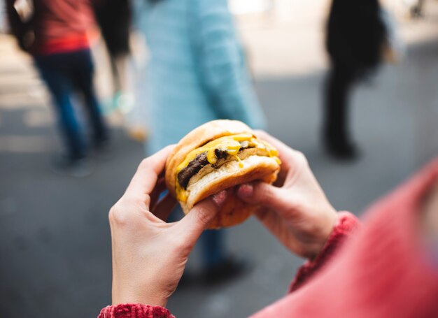 Close-up woman holding tasty burger
