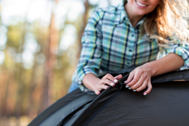 Close-up woman holding the tent