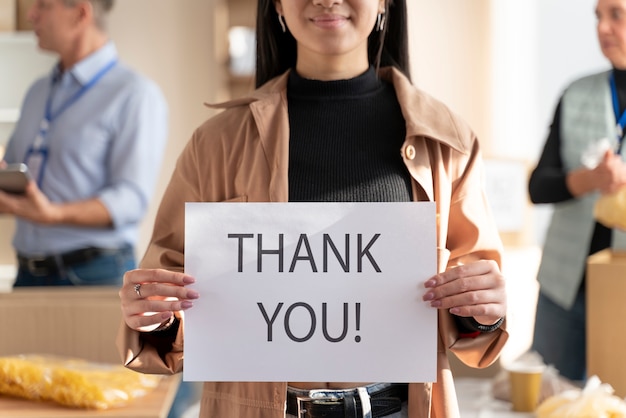 Close up woman holding thank you sign