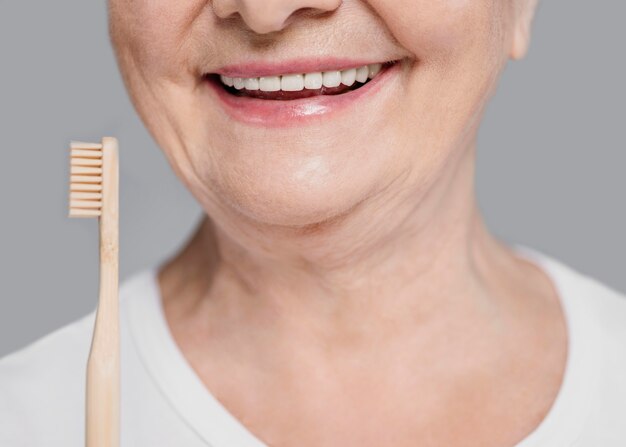 Close-up woman holding toothbrush