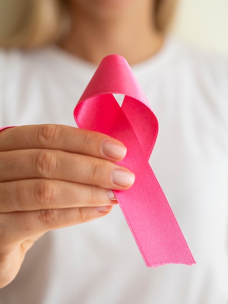 Close-up woman holding up awareness ribbon