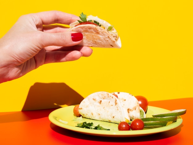 Close-up woman holding up tasty taco