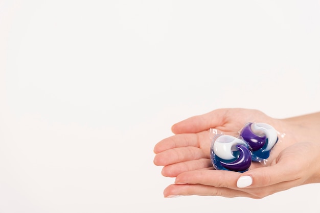 Close-up woman holding washing tablets