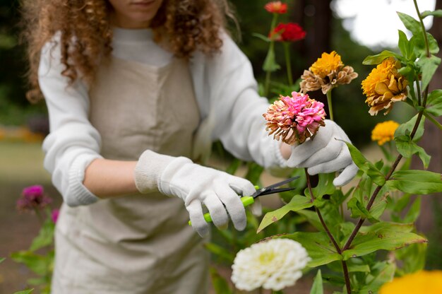 Close up woman holding watering gloves