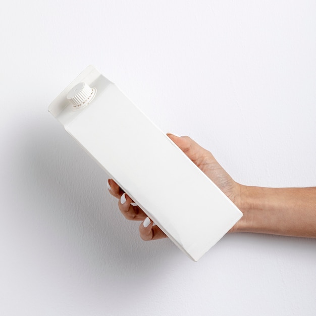 Close-up woman holding white cardboard container