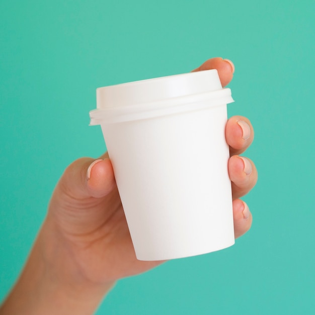 Close-up woman holding white coffee cup