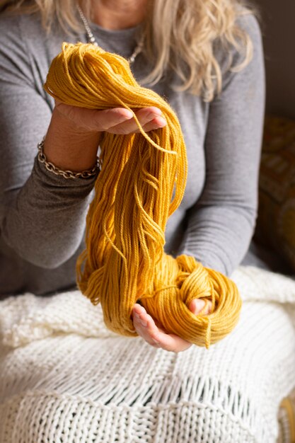 Close-up woman holding wool for knitting