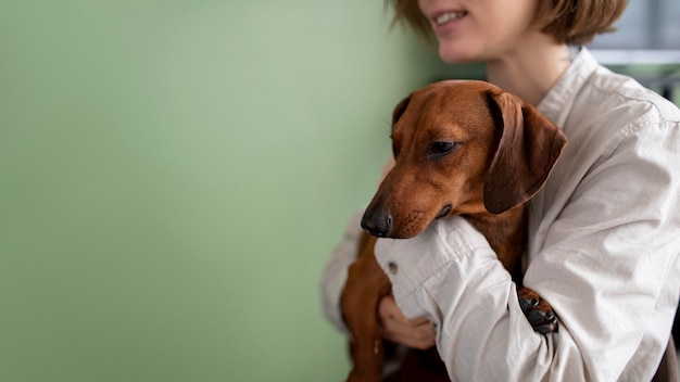 Free photo close up on woman hugging her pet dog