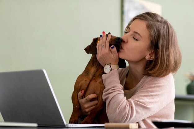 Close up on woman hugging her pet dog