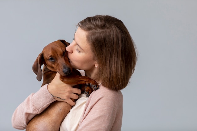 Close up on woman hugging her pet dog