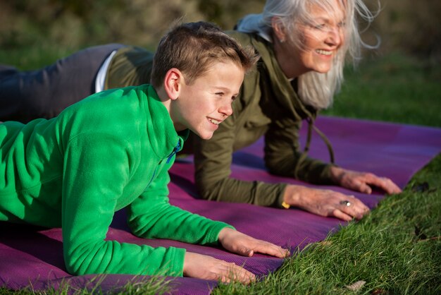 Close up woman and kid doing yoga