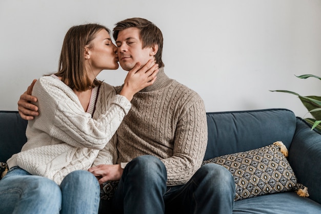 Free photo close-up of a woman kissing her husband