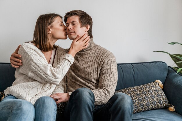 Close-up of a woman kissing her husband