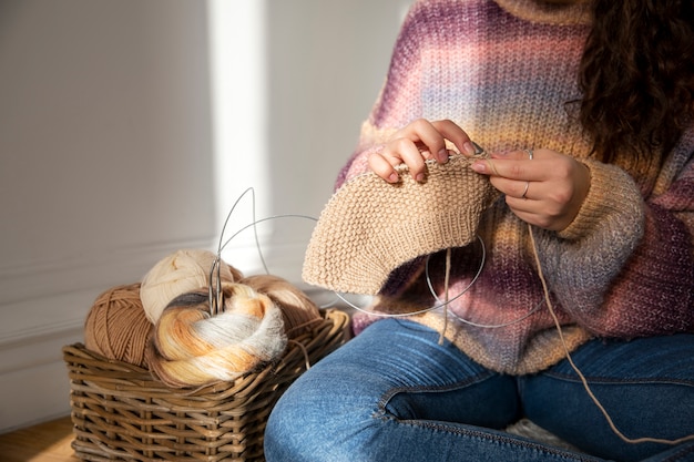 Close up woman knitting on floor