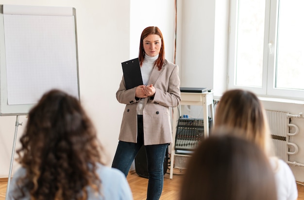 Close up woman leading therapy meeting