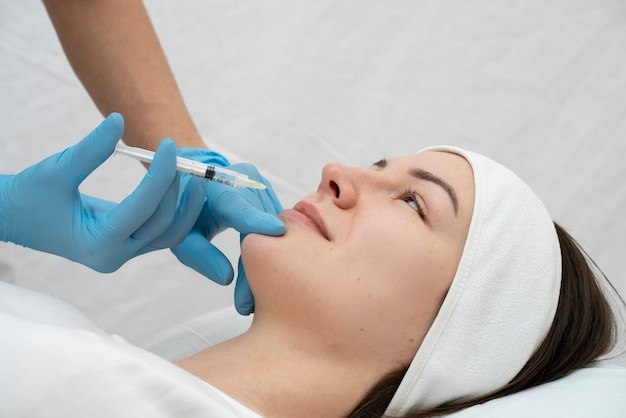 Close up on woman during lip filler procedure