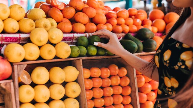 Close-up woman looking at fruits