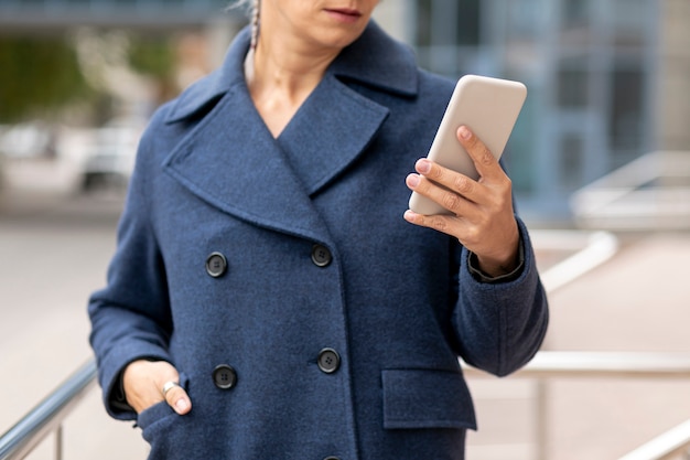 Close-up woman looking at smartphone