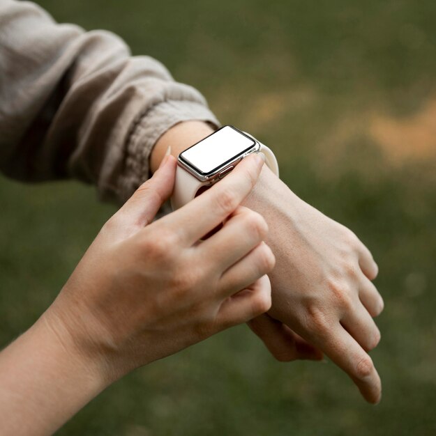 Close-up woman looking at smartwatch