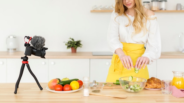 Foto gratuita donna del primo piano che produce insalata