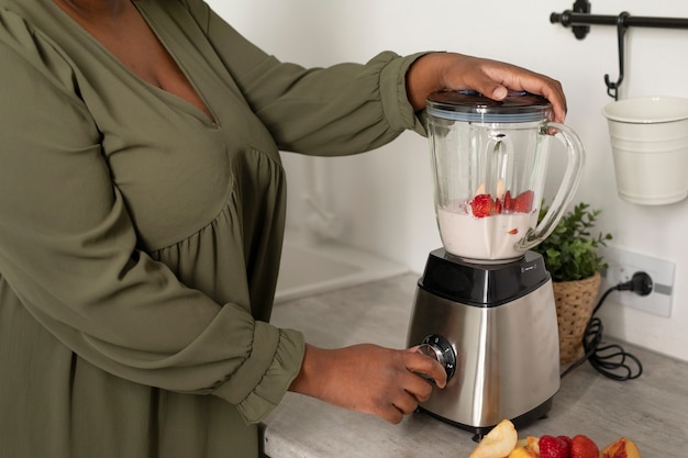 Close up woman making smoothie