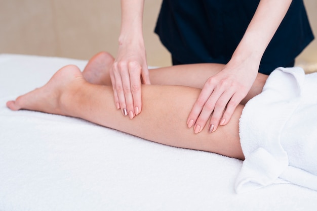 Close-up woman massaging a client