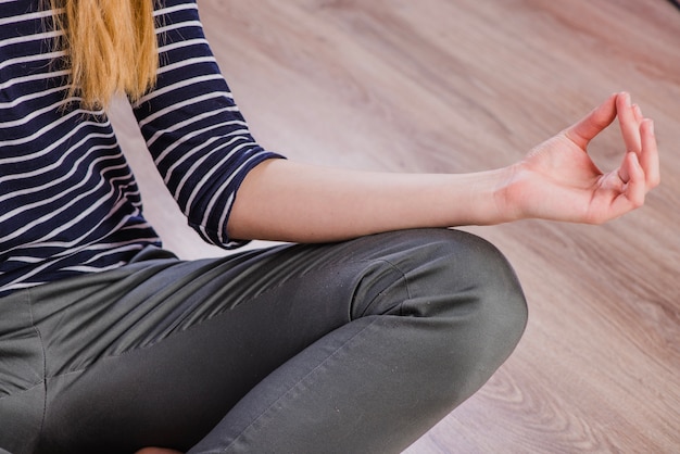 Free photo close-up woman meditating on floor