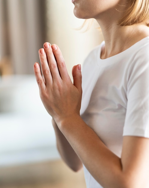 Free photo close up woman meditating indoors