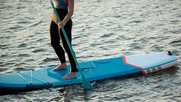 Close up woman paddleboarding