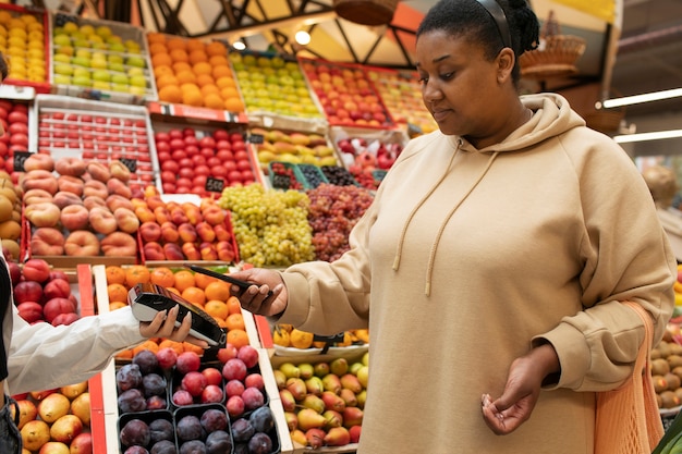 Close up woman paying at market