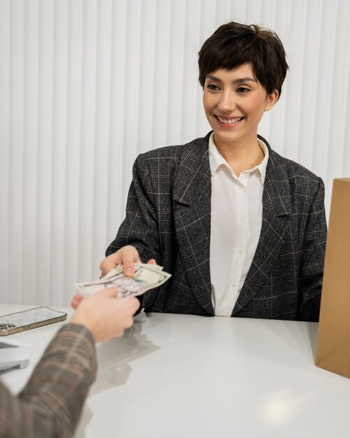 Close up woman paying with cash