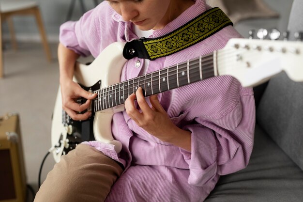 Close up woman playing the guitar