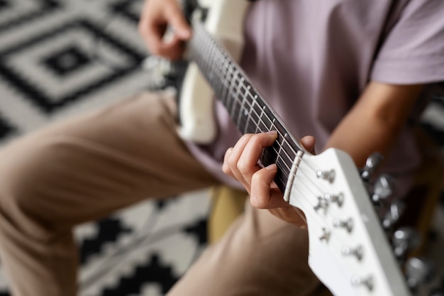 Close up woman playing the guitar