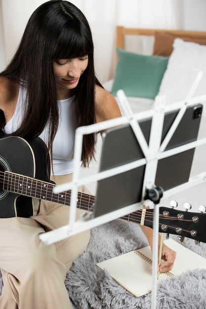 Close up woman playing the guitar