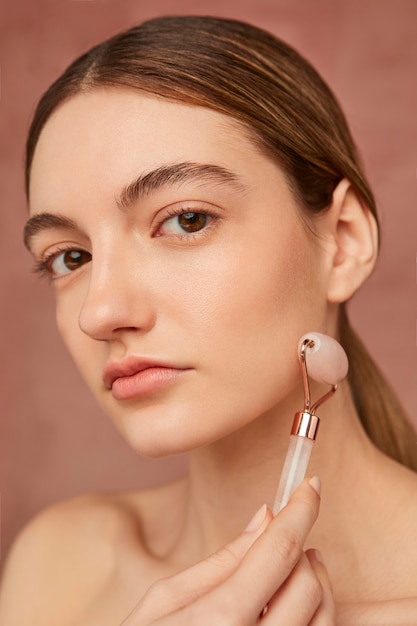 Close up woman posing with face tool