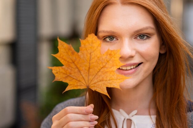 Close-up woman posing with leaf