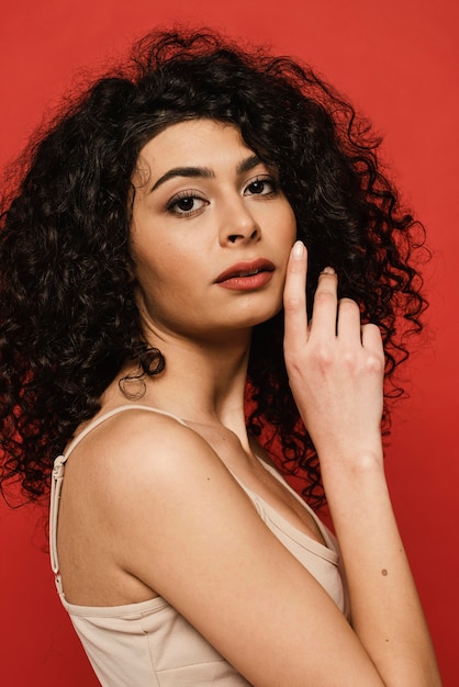 Close-up woman posing with red background